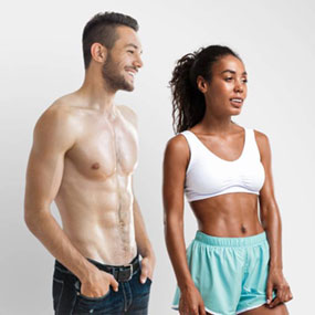 Fit man and woman pose together in workout attire modeling toned, lean muscles for Emsculpt NEO body contouring treatment.
